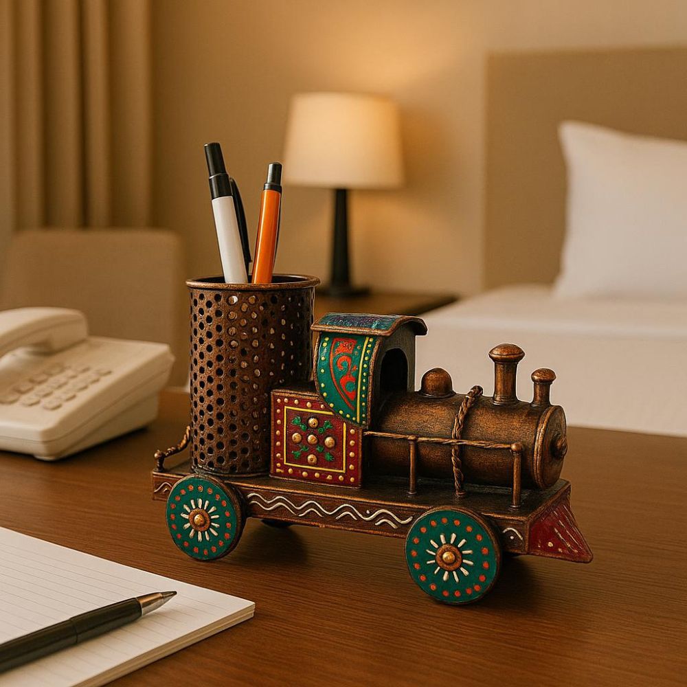 Handcrafted wooden train-shaped pen stand placed on a desk holding pens, ideal for home and office décor